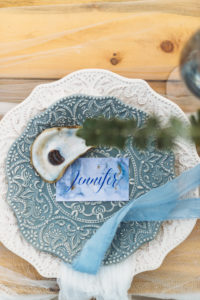 Coastal Beach Redington Shores Wedding Reception Decor, Dusty Blue Textured Plate on Ivory Textured Plate, Custom Watercolor Blue Script Place Card with Oyster Shell and Blue Tulle Ribbon