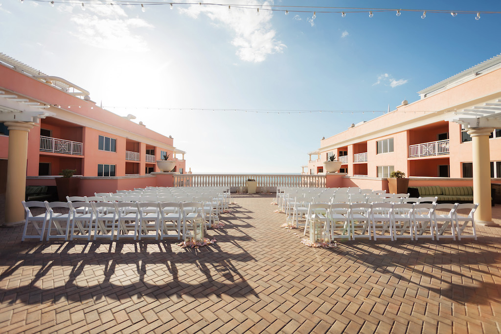 Waterfront Hotel Rooftop Elegant Wedding Ceremony with White Folding Chairs, Ivory and Blush Pink Rose Petals and White Lanterns | Venue Hyatt Regency Clearwater Beach | Tampa Bay Wedding Planner and Coordinator Special Moments Event Planning