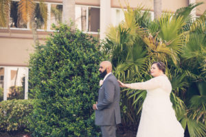 Outdoor Bride and Groom First Look Portrait, Long Sleeve Illusion, V-Neck Lace and Rhinestone Floral Accent Wedding Dress, Groom in Grey Suit with Rose Boutonniere | Tampa Bay Wedding Photographer Luxe Light Photography