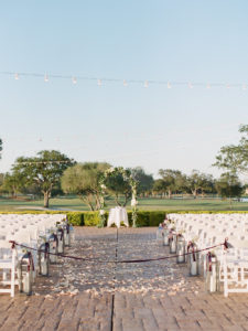 Outdoor Golf Course Ceremony, Organic Greenery, White Hydrangeas, and White Flower Inspired Arch, White Folding Chairs, Silver Lanterns Decor | Clearwater Wedding Venue Feather Sound Country Club Wedding