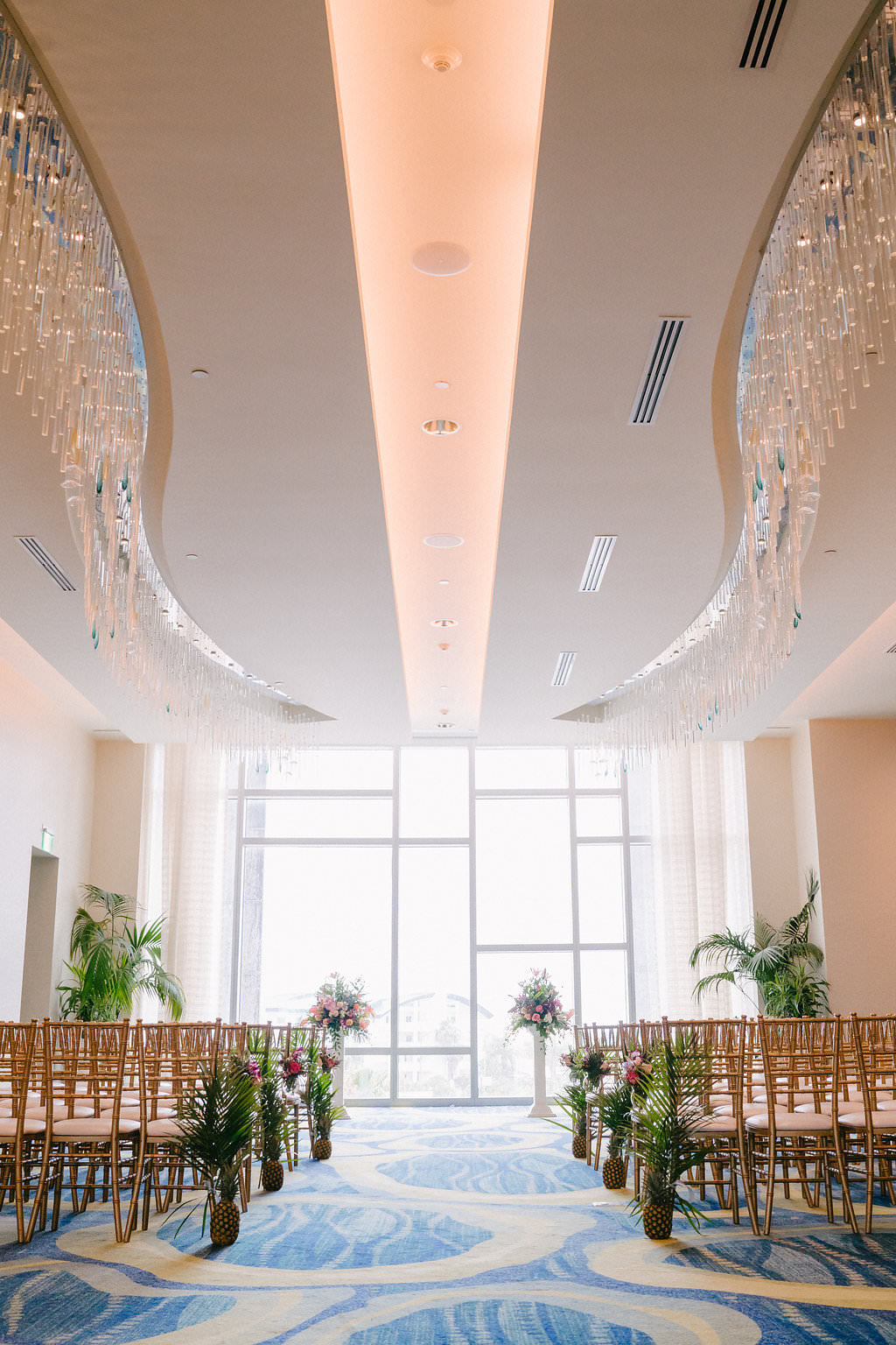 Indoor Hotel Wedding Ceremony with Gold Chiavari Chairs and Tropical Florals | Tampa Bay Photographer Grind and Press | Clearwater Beach Opal Sands Resort | Planner Special Moments Event Planning