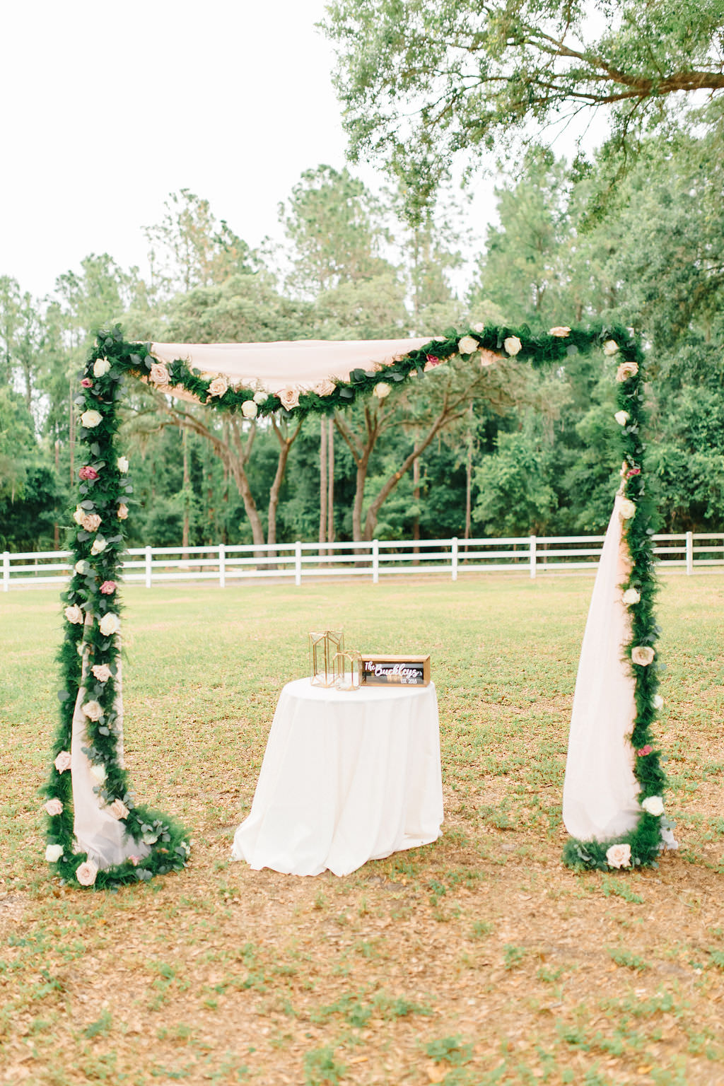 Outdoor Wedding Reception Decor, Arch with White Draping, Greenery Garland and White Flowers and Ceremony Table with White Tablecloth | Tampa Bay Wedding Planner Burlap to Lace