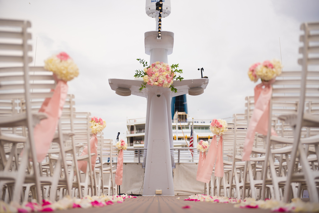 Wedding Ceremony Decor, White Folding Chairs, Pink and White Rose Petals, Ivory Floral Bouquets and Blush Pink Sashes | Downtown Tampa Waterfront Wedding Venue Yacht Starship