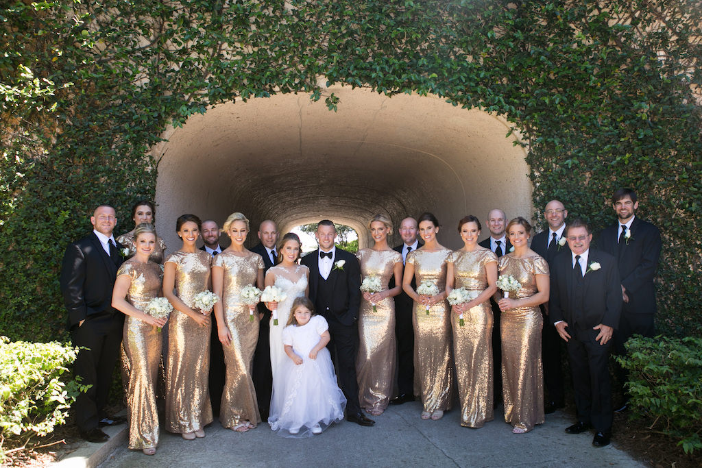 Outdoor Elegant Wedding Party Portrait, Groom and Groomsmen in Black Tuxedos, Bridesmaids in Matching Long Gold Sequin Dresses, Bride in Maggie Sottero Illusion Tank Top with Beaded Lace Motif Wedding Dress, Flower Girl in White Tulle Skirt Dress | Sarasota Wedding Photographer Carrie Wildes Photography | Venue Lakewood Ranch Golf and Country Club