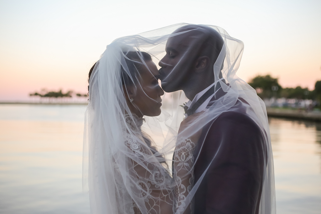 Creative Outside Waterfront Dark Sunset Bride and Groom Wedding Portrait Under Veil | St. Petersburg Photographer Lifelong Photography Studios