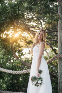 Sunset Outdoor Bridal Portrait in Lace Bodice with Lace Straps Empire Waist Wedding Dress with Greenery and Ivory Floral Bouquet