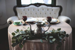 Old English Inspired Sweetheart Table Wedding Reception Decor, Vintage Silver Teapot on Greenery, White Vintage Couch on Bush Pink Sparkle Linen | St. Pete Florist Cotton & Magnolia