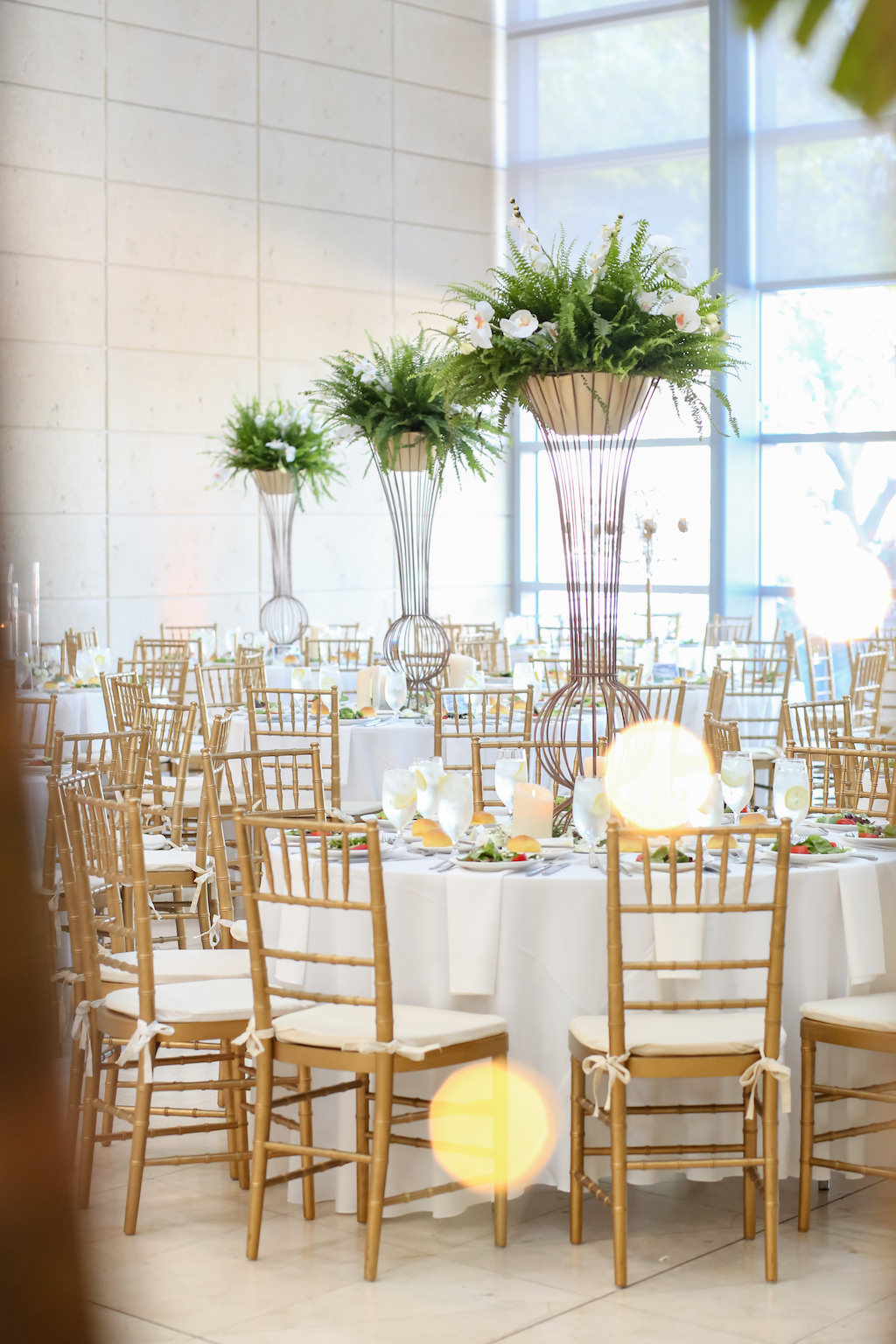 Wedding Reception Decor, Round Tables with White Tablecloths, Gold Chiavari Chairs, Tall Geometric Vase with Greenery and White Orchids Centerpiece | Tampa Bay Photographer Lifelong Photography Studios | St. Petersburg Venue Fine Arts Museum
