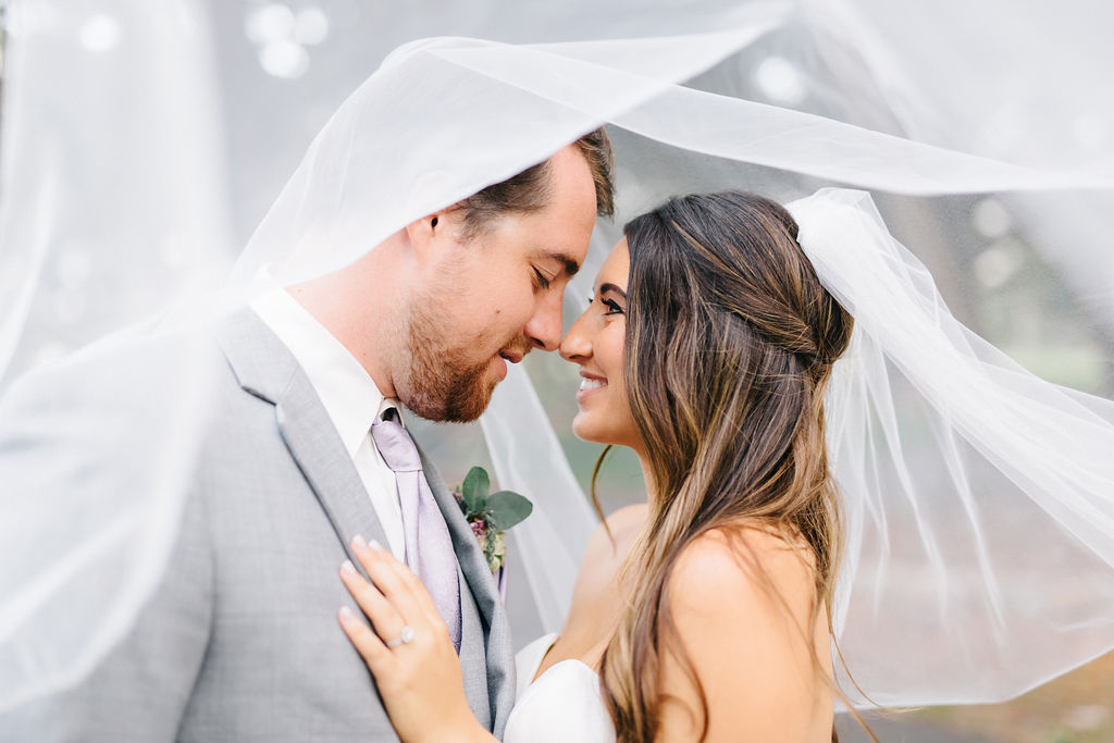 Creative Outdoor Bride and Groom Wedding Portrait Under Veil, Groom in Grey Suit with Lilac Tie | Tampa Bay Wedding Planner Burlap to Lace