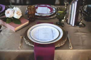 Old English Wedding Reception Decor, Vintage Gold Chargers, Maroon Linen, Satin Gold Tablecloth, Antique Books, Garden Roses and Candlesticks