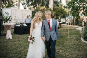 Outdoor Wedding Reception Bride and Groom Portrait, Bride in Empire Waist Lace Bodice and Lace Strap Dress with Ivory, Burgundy and Greenery Floral Bouquet, Groom in Blue Paisley Suit with Burgundy Red Tie | Tampa Bay Wedding Planner Kelly Kennedy Weddings and Events