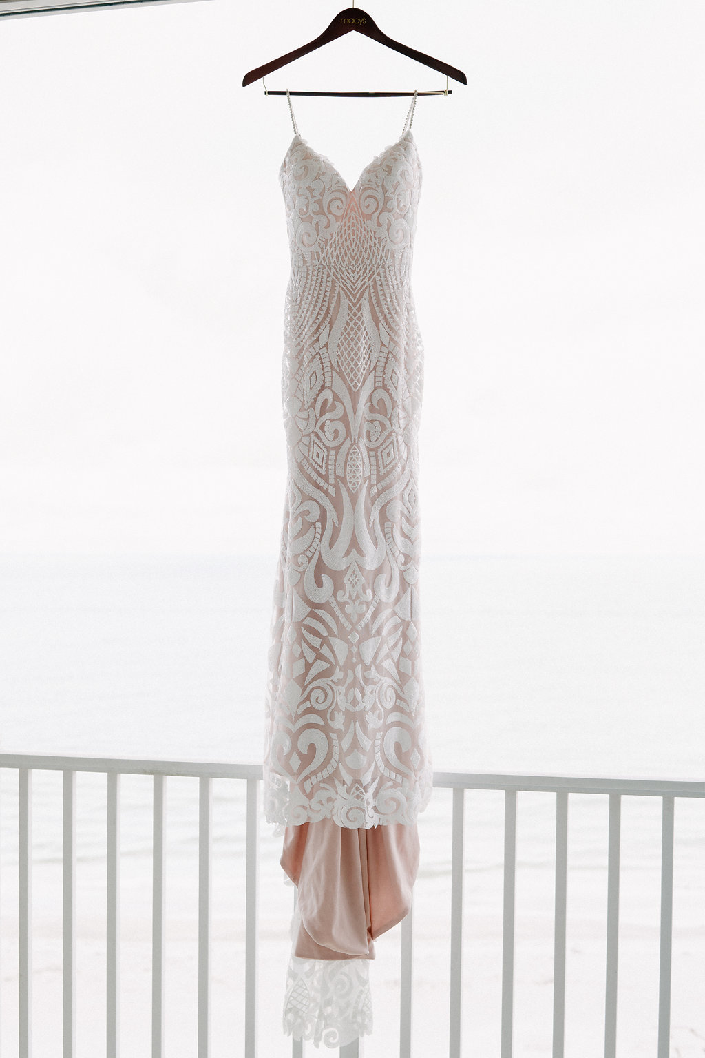 Plunging Neckline Ivory Sequin Lace and Nude Lining Spaghetti Strap Wedding Dress on Hanger | Tampa Bay Photographer Grind and Press Photography