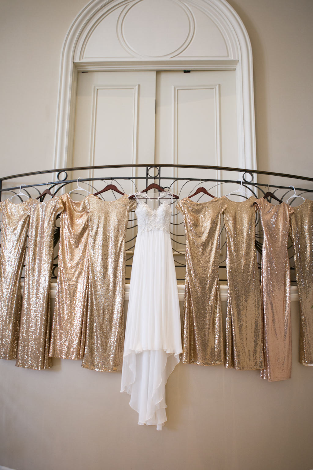 Maggie Sottero A-Line Illusion Wedding Dress with Lace Applique and Rhinestone Beaded Bodice, Gold Sequin Bridesmaid Dresses on Hangers | Sarasota Wedding Photographer Carrie Wildes Photography