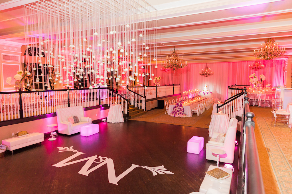 Elegant Hotel Ballroom Wedding Reception Decor with White Couch Lounge Area, Custom Projection Lighting, Pink Uplighting, Hanging White Roses | St Pete Beach Historic Hotel Wedding Venue The Don CeSar