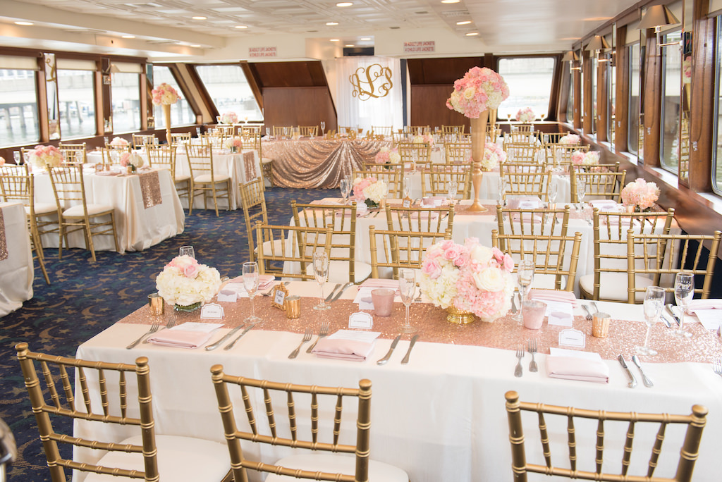 Elegant, Glamorous Wedding Reception Decor with White Tablecloths, Gold Chiavari Chairs, Blush Pink and Glitter Table Runner, Blush Pink Linens, Rose and Pink High and Low Floral Centerpieces in Gold Vases, Gold Lasercut Monogram | Tampa Bay Waterfront Wedding Venue Yacht StarShip | Kate Ryan Linens and Rentals
