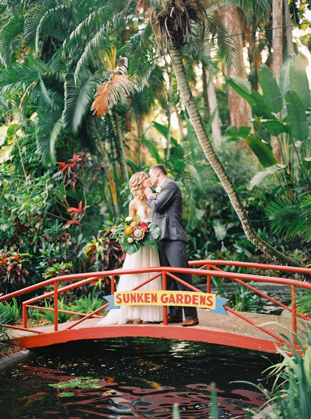 Tropical Outdoor Inspired Bride and Groom Wedding Portrait on Bridge | Outdoor St. Petersburg Wedding Venue Sunken Gardens | Planner Southern Glam Events and Weddings