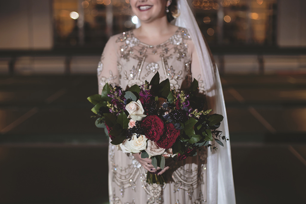 Outdoor Nighttime Bridal Wedding Portrait in Illusion Long Sleeve Cream Floral Beading Embellished Wedding Dress with Satin Belt, Cathedral Length Veil and Fuchsia, Dark Maroon, Blush Pink and Greenery Floral Bouquet | Tampa Bay Florist Cotton & Magnolia