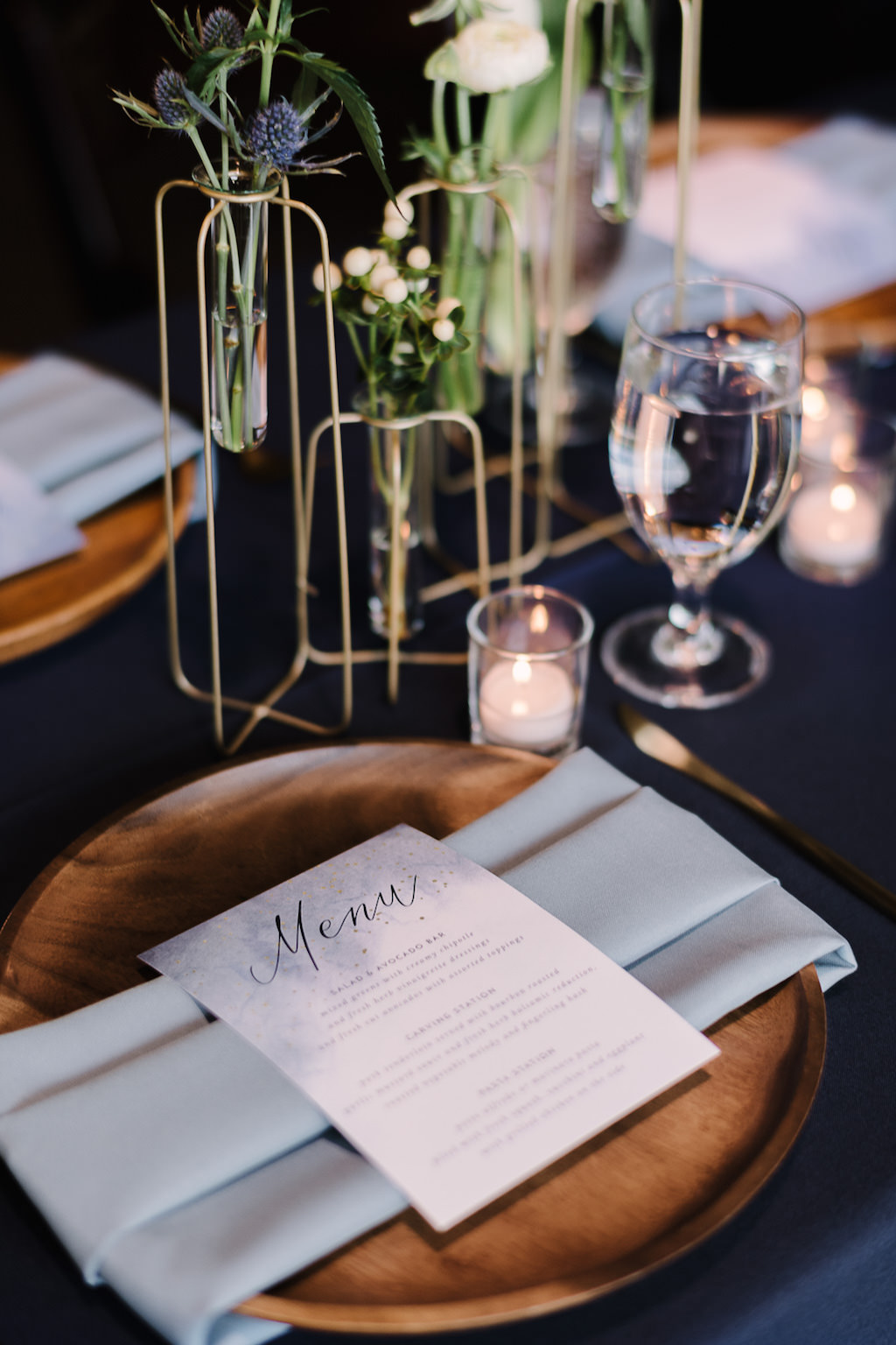 Wooden Charger with Dusty Blue Linen and Menu, Gold Wire Vases with Green Florals | Tampa Bay Rentals Over the Top Linens