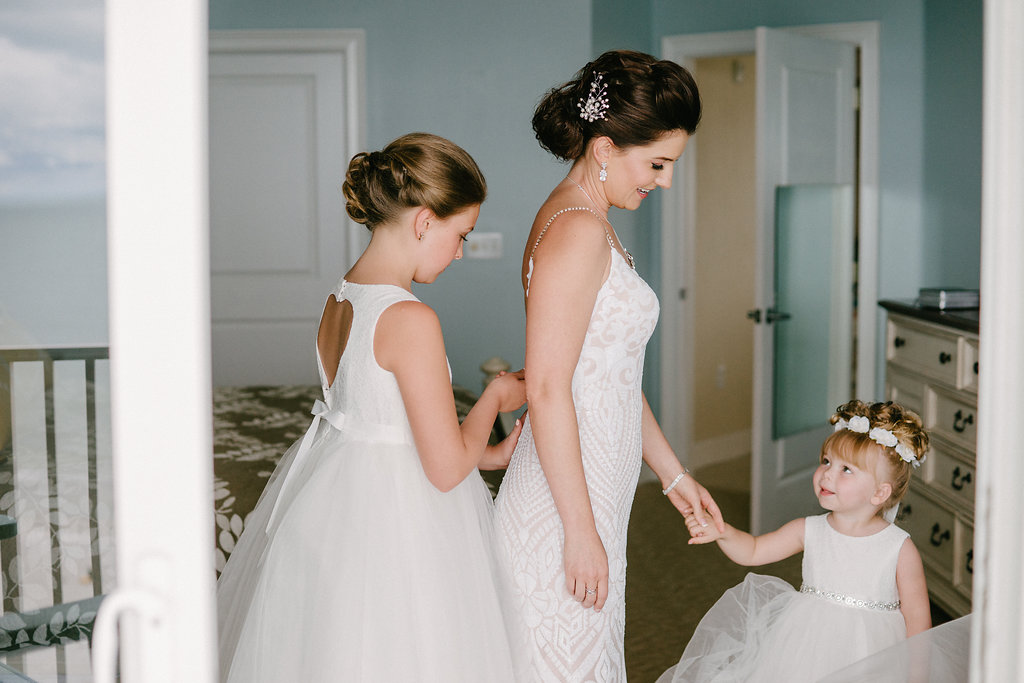 Bride Getting Ready Portrait with Flower Girls in White Tulle Skirt Dresses, Bride in Plunging Neckline Ivory Sequin Lace and Nude Lining Rhinestone Spaghetti Strap Wedding Dress | Tampa Bay Photographer Grind and Press | Hair and Makeup Michele Renee the Studio