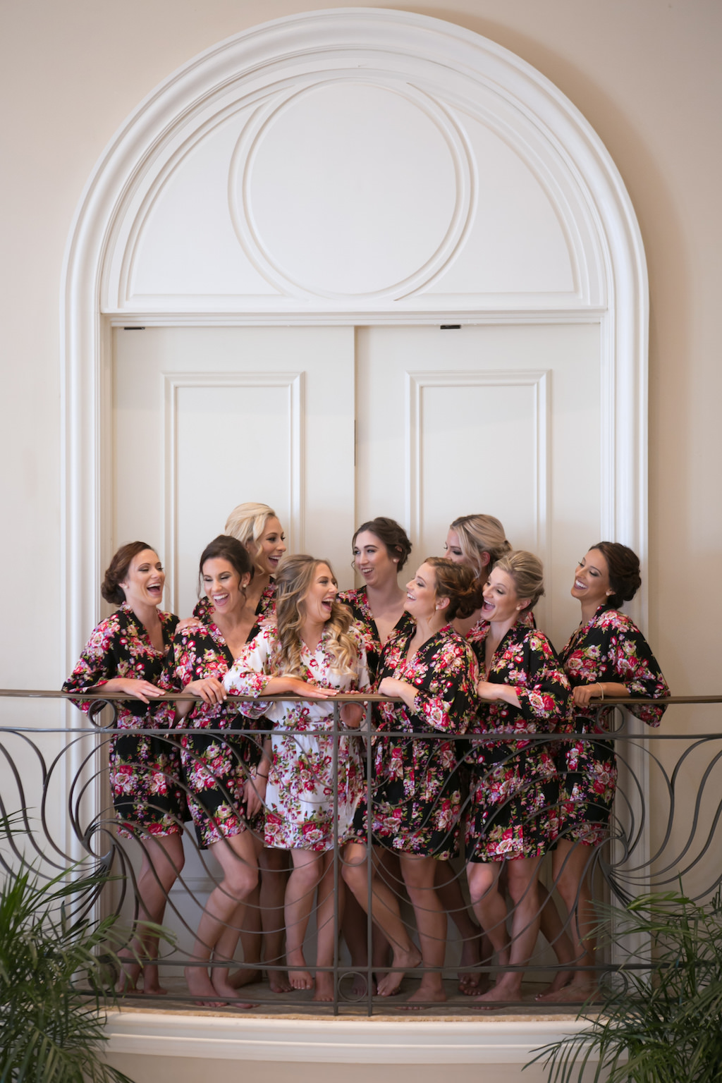 Balcony Bridal Party Getting Ready Portrait, Bridesmaids in Matching Black and Pink Floral Silk Robes, Bride in White Floral Silk Robe | Sarasota Wedding Photography Carrie Wildes Photography