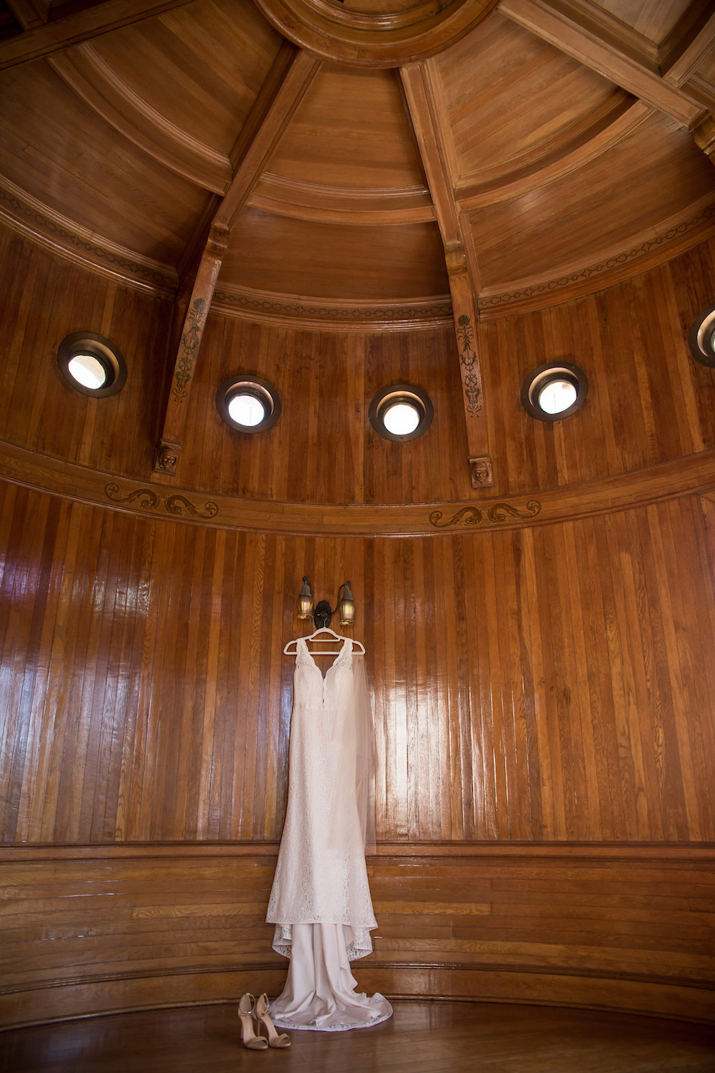 Lace Tank Top Strap Plunging Neckline Lace Wedding Dress Hanging in Wood Paneled Room | Tampa Bay Photographer Cat Pennenga Photography | Venue Powel Crosley Estate
