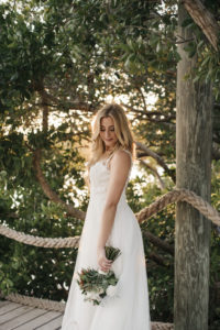 Outdoor Bride Wedding Portrait in A-Line Lace and Straps Wedding Dress with Greenery and Ivory Floral Bouquet | Tampa Bay Wedding Planner Kelly Kennedy Weddings and Events