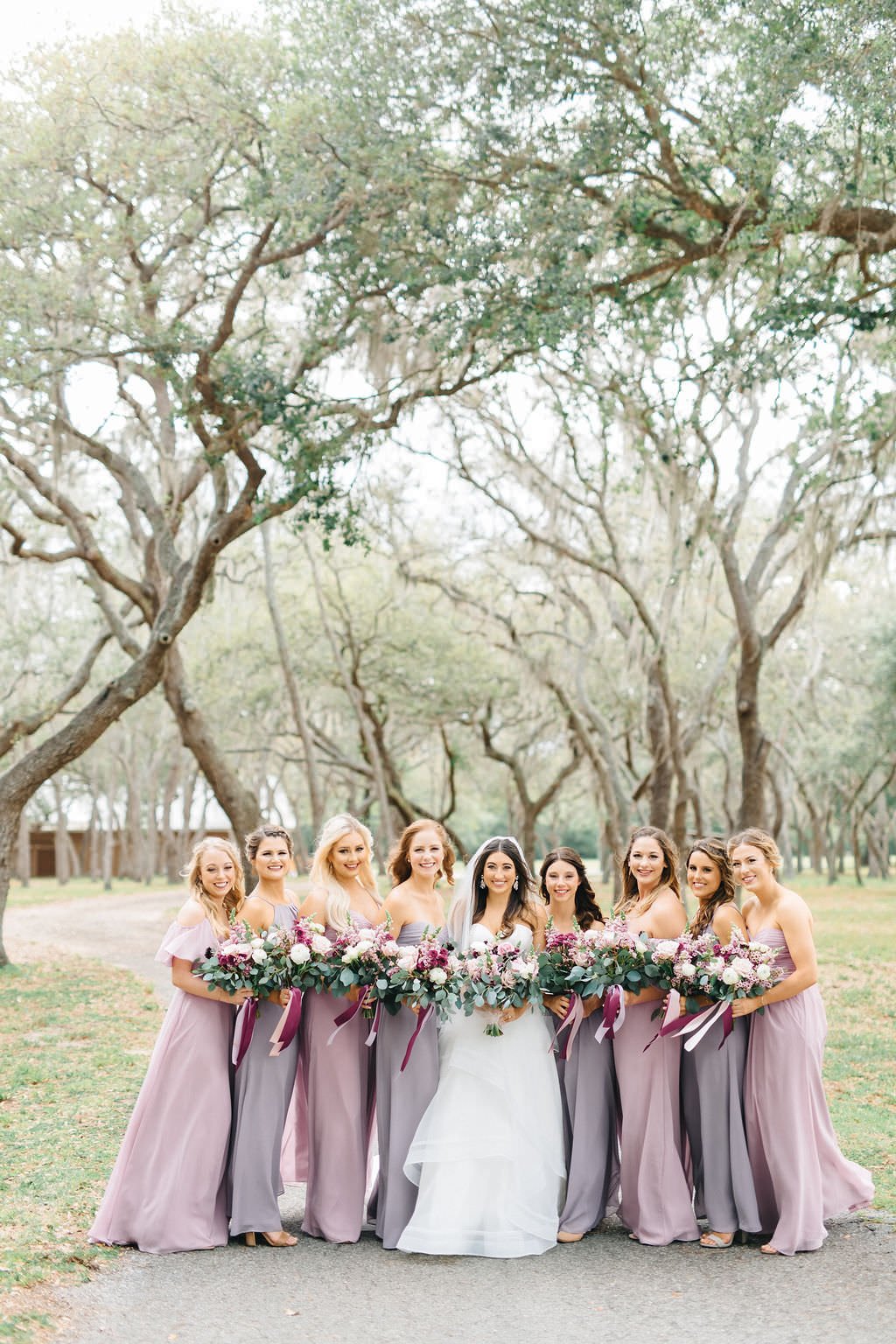 Outdoor Bride and Bridesmaids Wedding Portrait in Sweetheart Strapless Ballgown Wedding Dress and Veil with Pink, White and Greenery Floral Bouquet, Bridesmaids in Mismatched Mauve/Lilac Dresses | Tampa Bay Wedding Planner Burlap to Lace | Tampa Venue The Lange Farm