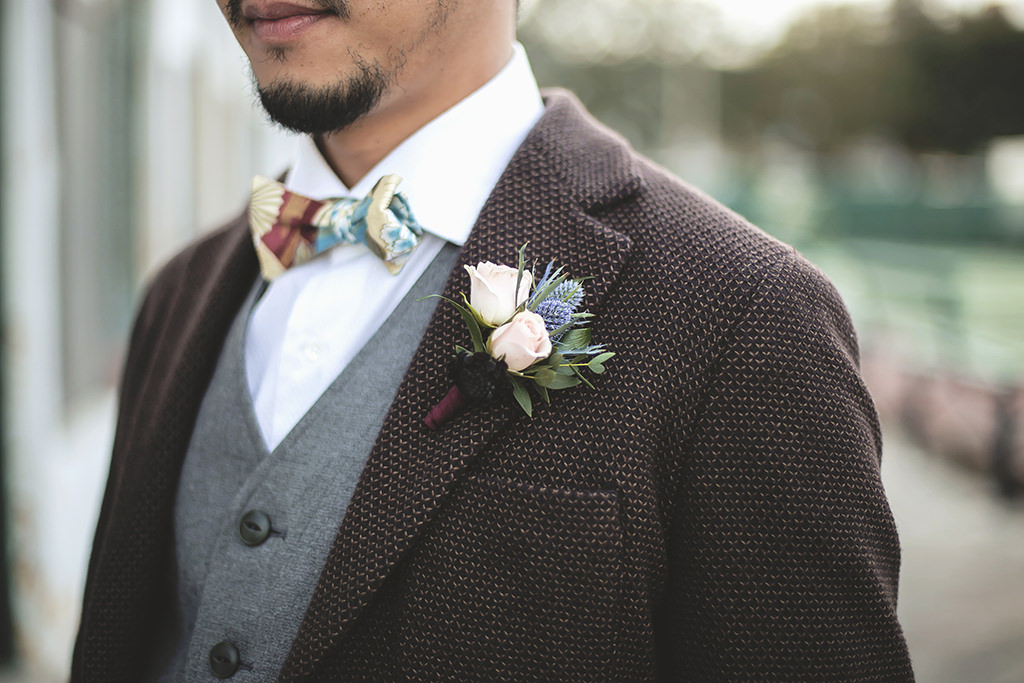 Groom Wedding Portrait, Dark Brown English Inspired Tweed Tuxedo, Grey Vest, Colorful Bowtie, Blush Pink and Greenery Boutonniere | St. Petersburg Florist Cotton & Magnolia
