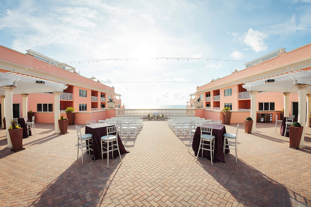 Outdoor Roof Terrace Wedding Ceremony Decor, White Folding Chairs, Hightop Bar Tables with Dark Purple Tablecloth, Tall Silver Chairs | Luxury Destination Wedding Venue Hyatt Regency Clearwater Beach | Over the Top Linen Rentals