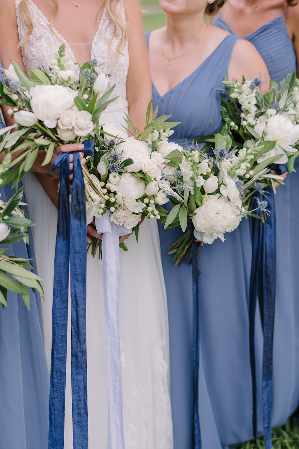 Outdoor Bridal Party Portrait, Bride in Plunging V Neck Illusion Lace A Line Wedding Dress, Bridesmaids in Dusty Blue Tank Top Dresses and White and Greenery Floral Bouquets