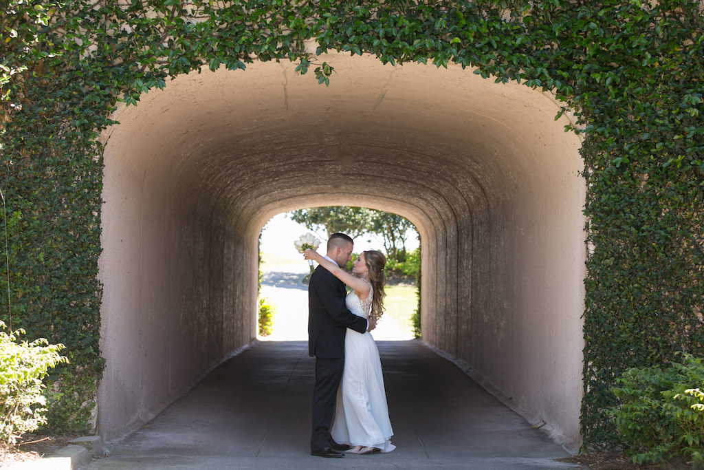 Outdoor Bride and Groom Wedding Portrait Underneath Greenery Bridge | Sarasota Wedding Photographer Carrie Wildes Photography | Venue Lakewood Ranch Golf and Country Club