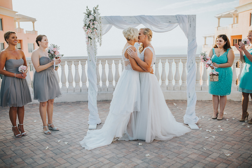 Clearwater Beach Florida Same Sex Gay Waterfront Hotel Rooftop Wedding Ceremony Portrait, Arch Wrapped in White Linen with Blush Pink, White and Greenery Bouquet | Venue Hyatt Regency Clearwater Beach