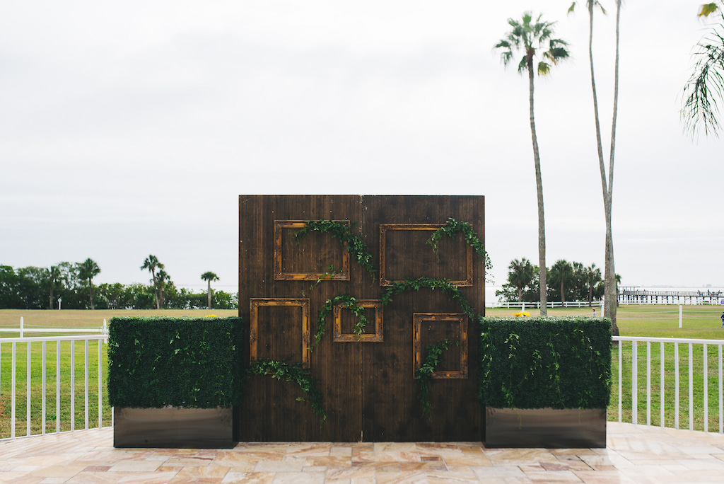 Modern Vintage Wedding Ceremony Decor, Two Tall Wooden Doors with Greenery and Two Green Plant Hedges | Venue Safety Harbor Resort and Spa