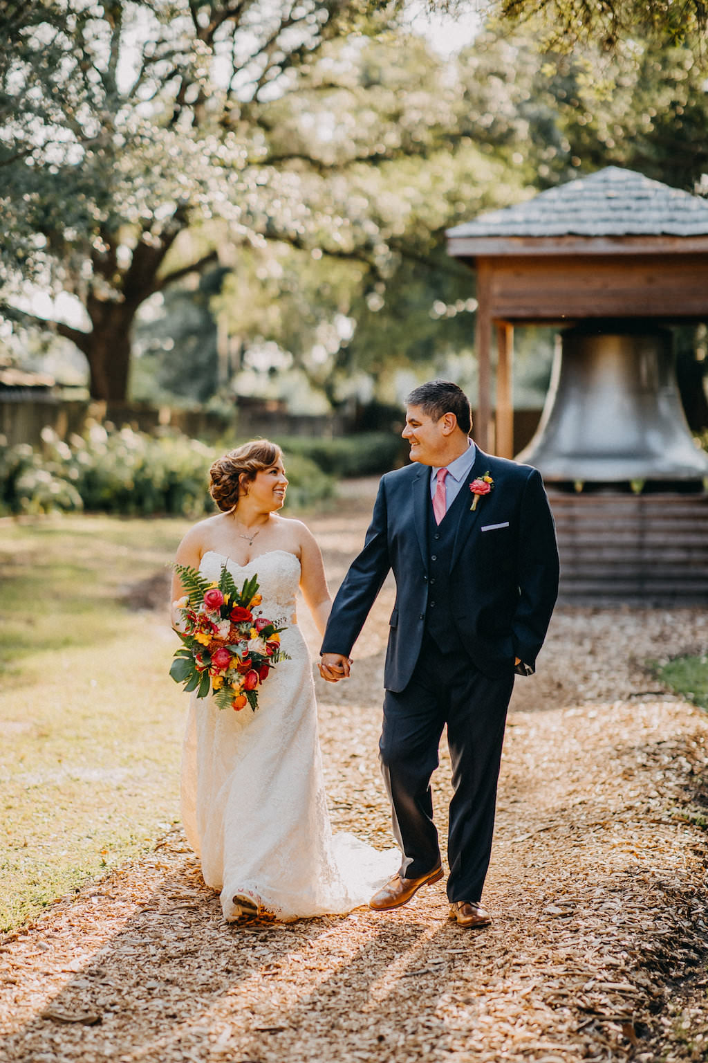 Outdoor Bride and Groom Wedding Portrait, Bride in A-Line Sweetheart Strapless Lace Wedding Dress with Tropical Floral Bouquet, Groom in Navy Blue Suit and Pink Tie | Tampa Bay Photographer Rad Red Creative | Rustic Venue Cross Creek Ranch