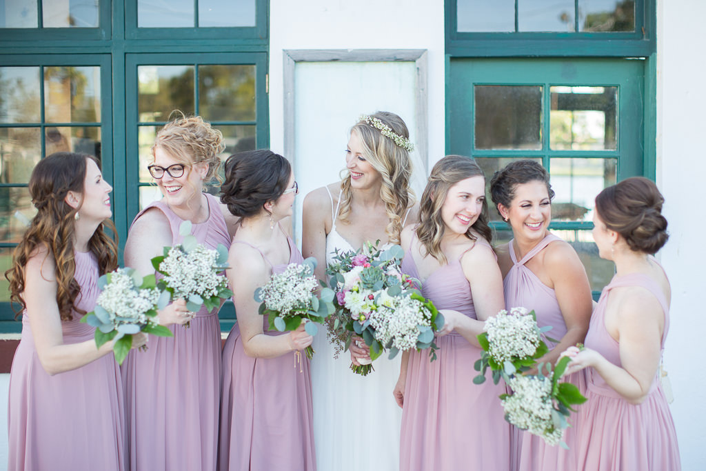 Bride and Bridesmaids Wedding Portrait, Bridesmaids in Dusty Rose Mismatched Dresses with Baby's Breathe Bouquets, Bride in A-line Spaghetti Strap Lace Wedding Dress with Hair Curled Down and Floral Crown Hairpiece | Tampa Bay Hair and Makeup Femme Akoi Beauty Studio