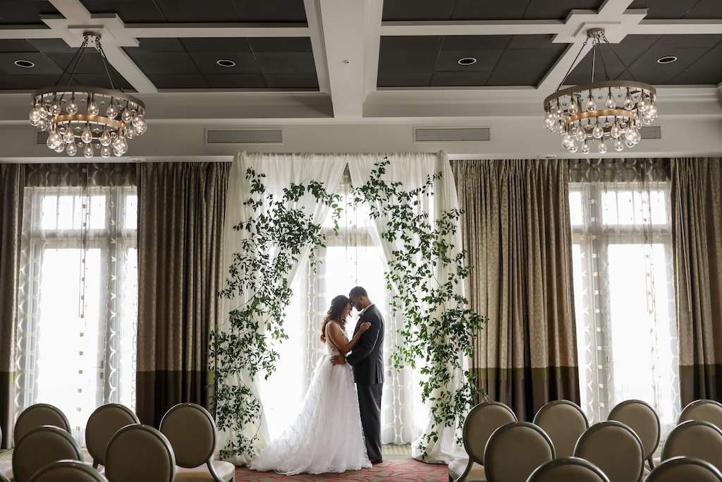 Elegant Boho Ballroom Wedding Ceremony Bride and Groom Portrait, White Draping Arch with Greenery | Tampa Bay Photographer Lifelong Photography Studios | Florist Cotton and Magnolia | Planner Parties A'La Carte | Downtown St.Pete Wedding Venue The Birchwood