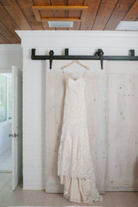 Sweetheart Strapless and Lace Wedding Dress Hanging from Door