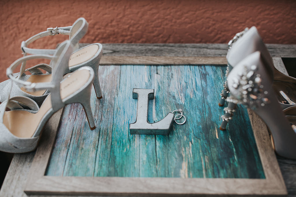 Silver Sparkle Strappy Sandal Strappy Stiletto Wedding Shoes and Silk Silver Pumps with Rhinestone Heel Wedding Shoes on Wooden and Teal Blue Sign with Letter L and Wedding Rings