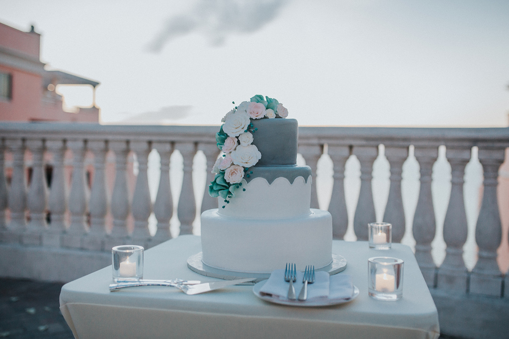 Three Tier Blue and White Wedding Cake with Cascading White and Blush Pink Florals | Venue Hyatt Regency Clearwater Beach