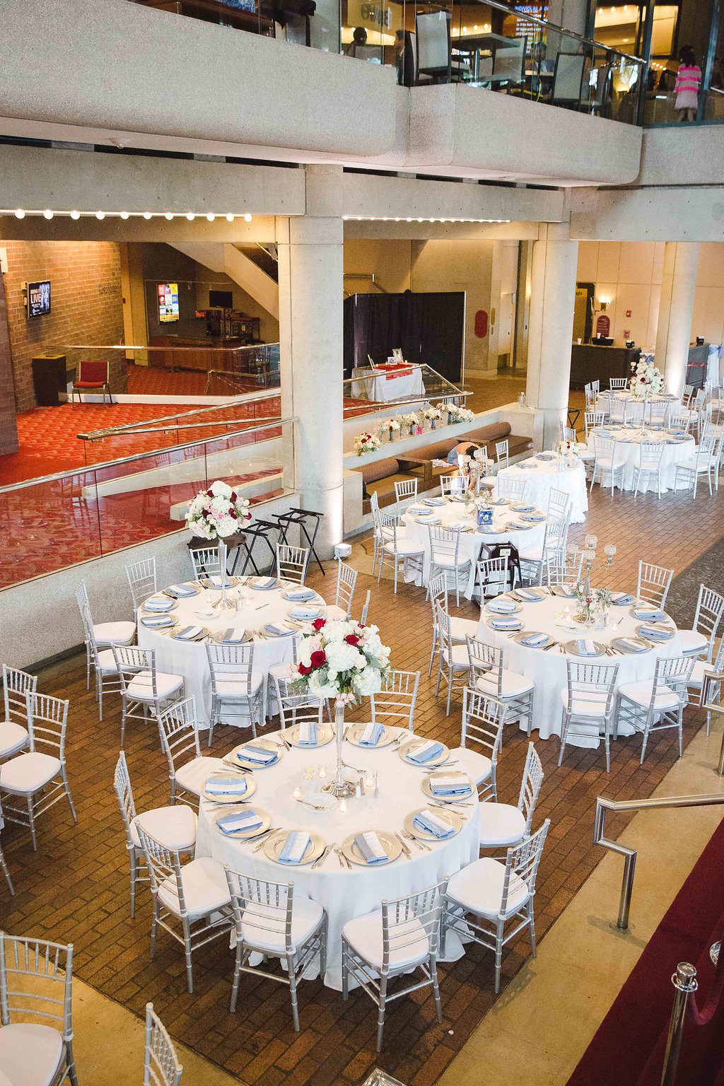 Wedding Reception Decor, Round Tables with White Tablecloths, Silver Chiavari Chairs, White and Red Floral Centerpieces, Pale Blue Linens | Tampa Bay Photographer Marc Edwards Photography | Tampa Venue Straz Center