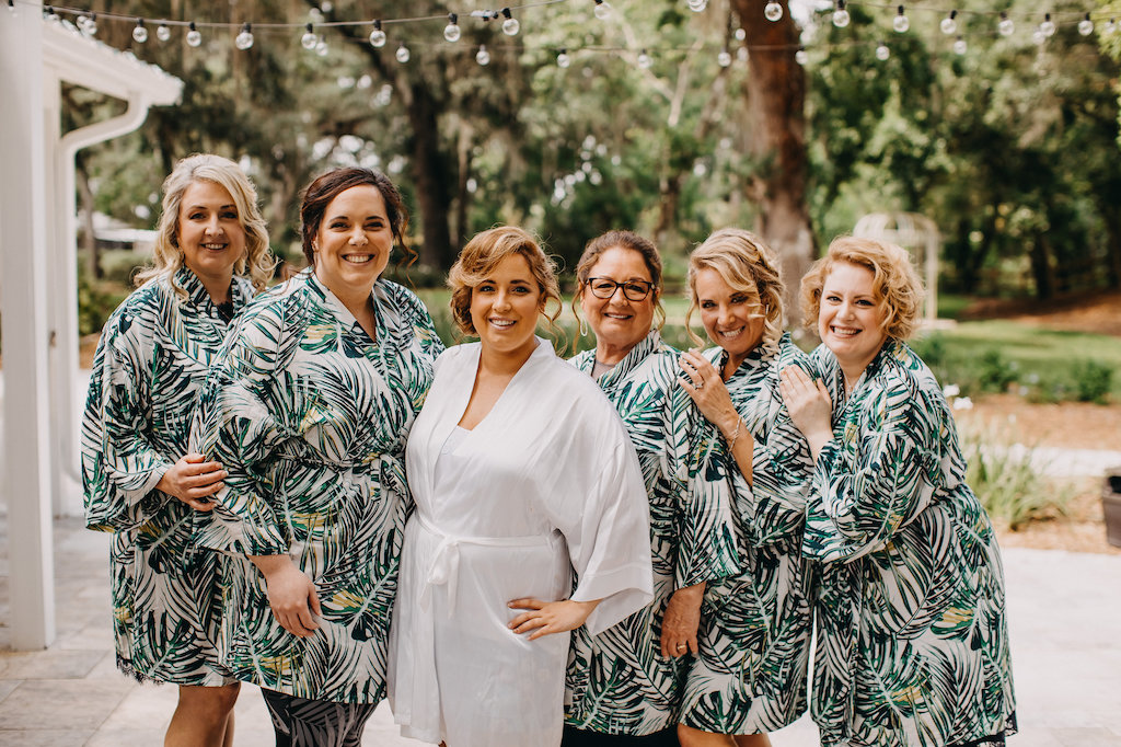 Outdoor Bride and Bridesmaids Getting Ready Portrait in Tropical Green Palm Tree Leaves Robes | Tampa Bay Photographer Rad Red Creative