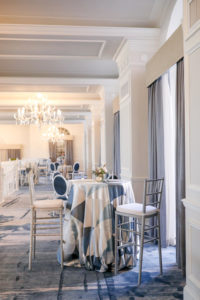 Renovated Ballroom at the Don Cesar Hotel Wedding Venue on St. Pete Beach, High Top Cocktail Tables with Blue and Silver Triangle Design Tablecloth, Tall Silver Chiavari Chairs with White Cushions | St. Petersburg Photographer Lifelong Photography Studios | Marry Me Tampa Bay Before 5 Networking Event | Designer UNIQUE Weddings and Events | Rentals Over the Top Linens and A Chair Affair
