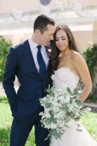 Outdoor Bride and Groom Wedding Portrait, Bride in Sweetheart Strapless Lace Wedding Dress with White and Greenery Floral Bouquet, Groom in Navy Blue Suit | St. Petersburg Hair and Makeup Femme Akoi