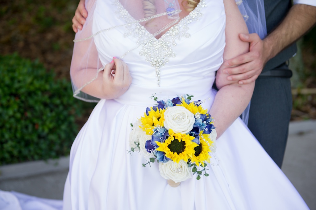 Outdoor Bride and Groom Portrait, Bride in Satin V-Neck Ballgown Wedding Dress with Straps and Rhinestone Beading with Yellow Sunflower, White Roses, Blue and Greenery Floral Bouquet | Tampa Bay Photographer Andi Diamond Photography
