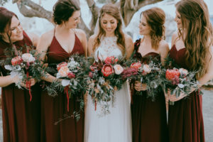 Bride and Bridesmaids Wedding Portrait, Bridesmaids in Long Burgundy Mismatched Style Dresses, Bride in High Neck Illusion and Lace Wedding Dress with, Red, Blush Pink, Greenery Organic Floral Bouquets | Tampa Bay Hair and Makeup Artist Michele Renee the Studio