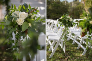 Outdoor Florida Garden Wedding Ceremony Decor, White Folding Chairs in Semi Circle Formation with Organic Greenery and White Rose Floral Bouquets on Tall Stands | Tampa Bay Photographer Cat Pennenga Photography | Sarasota Wedding Venue Marie Selby Botanical Gardens | Wedding Planner NK Productions