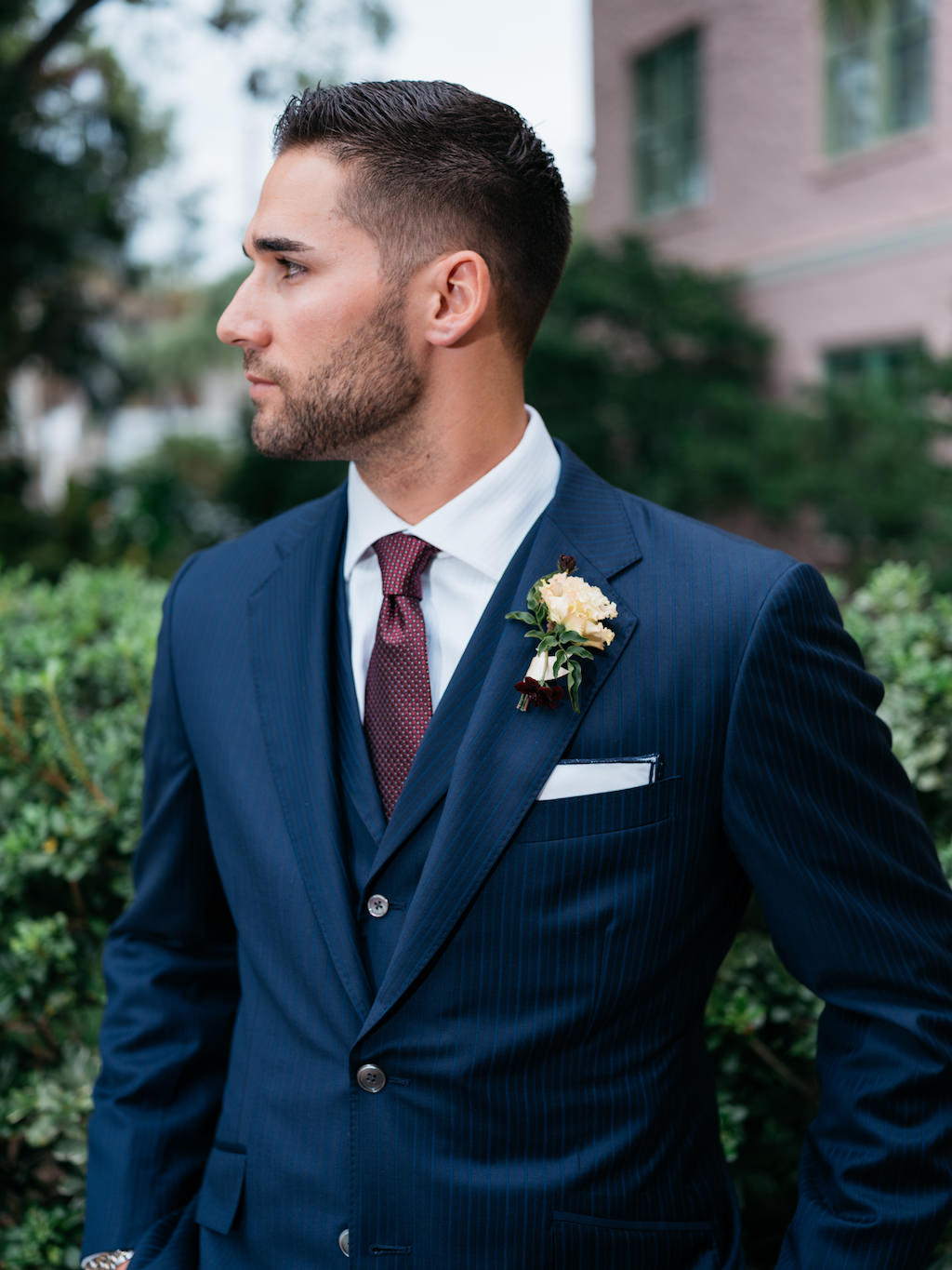 Tampa Bay Rays Professional Baseball Player Kevin Kiermaier Groom Wedding Portrait in Navy Blue Suit, Burgundy Tie, Ivory Floral Boutonniere