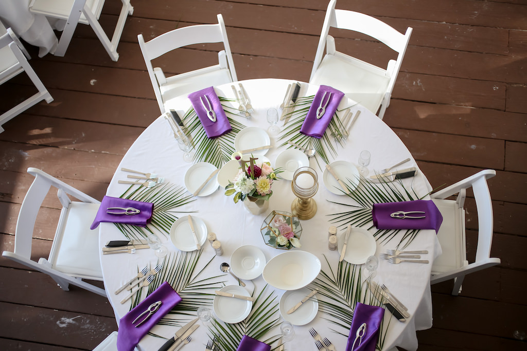 Tropical Wedding Reception Decor, Round Table with White Tablecloth, Purple Linens, Green Palm Tree Leaf, Low Floral Centerpiece | Tampa Bay Wedding Photographer Lifelong Photography Studios