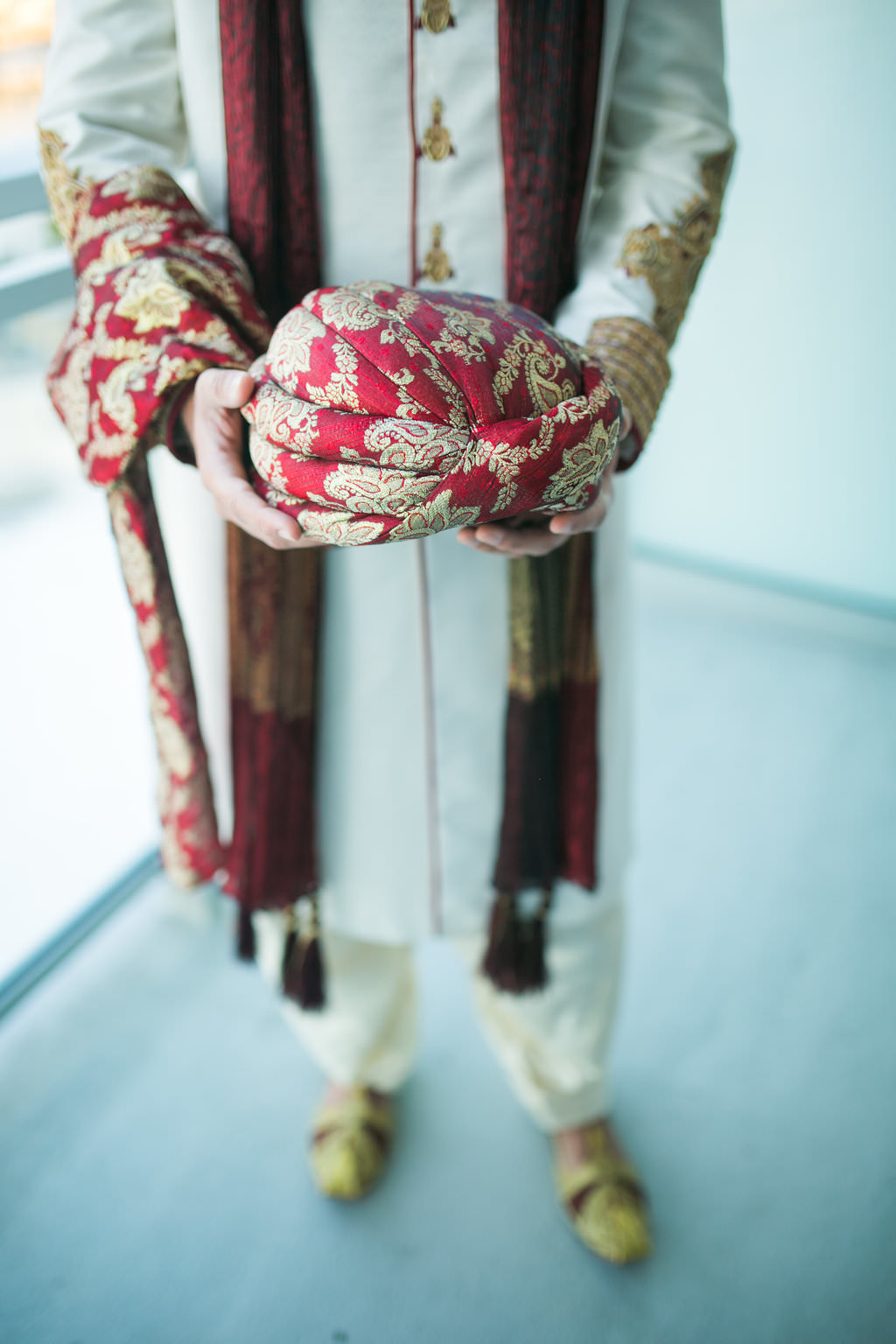 Glamorous Traditional Tampa Bay Indian Wedding, Groom Holding Red and Gold Turban