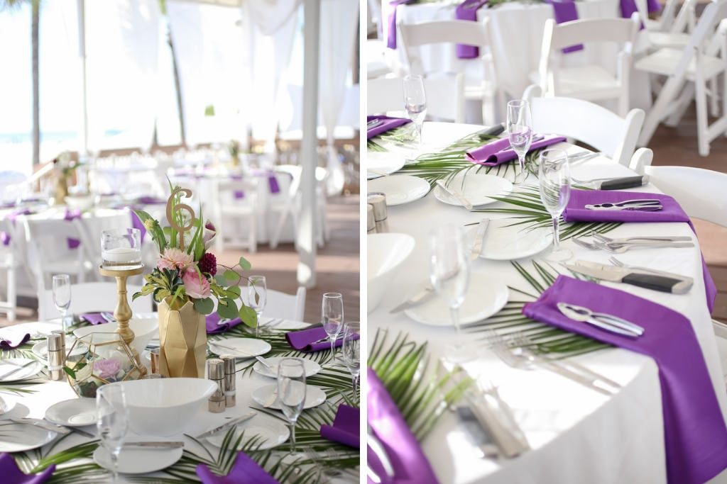 Tropical Wedding Reception Decor, Round Table with White Tablecloth, Purple Linens, Green Palm Tree Leaf, Low Floral Centerpiece in Gold Vase with Lasercut Gold Table Number and Candlestick | Tampa Bay Wedding Photographer Lifelong Photography Studios